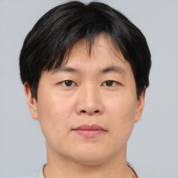 Neutral asian young-adult male with short  brown hair and brown eyes