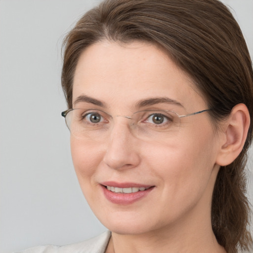 Joyful white adult female with medium  brown hair and brown eyes