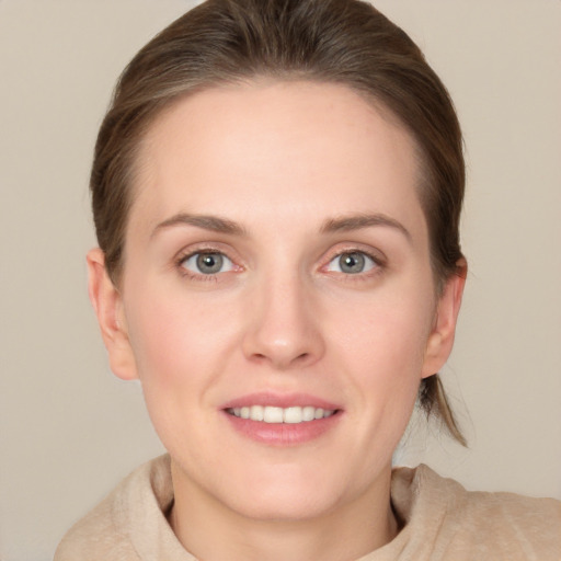 Joyful white young-adult female with medium  brown hair and grey eyes