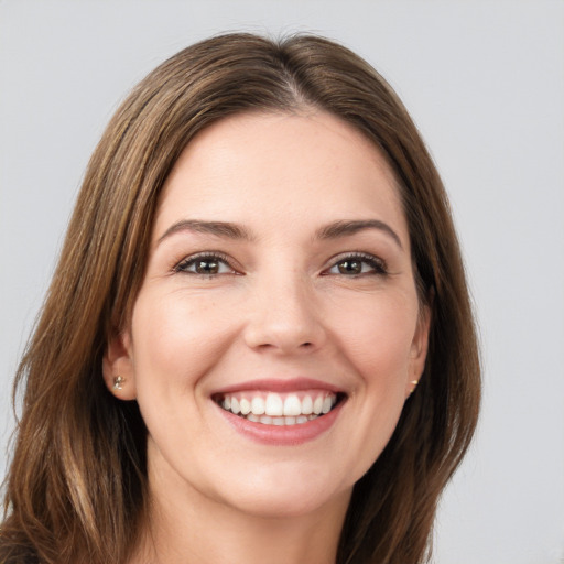 Joyful white young-adult female with long  brown hair and brown eyes