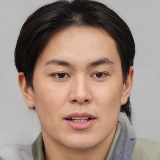 Joyful asian young-adult male with medium  brown hair and brown eyes