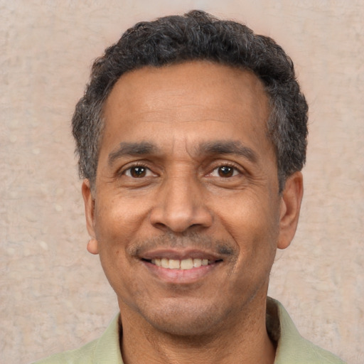 Joyful latino adult male with short  black hair and brown eyes