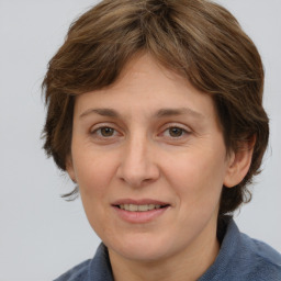 Joyful white adult female with medium  brown hair and grey eyes