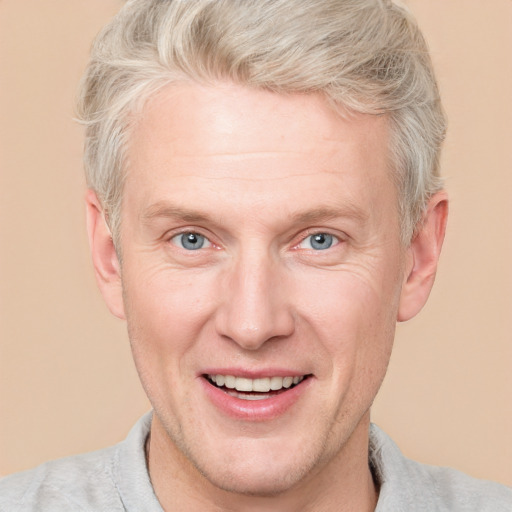 Joyful white adult male with short  brown hair and grey eyes