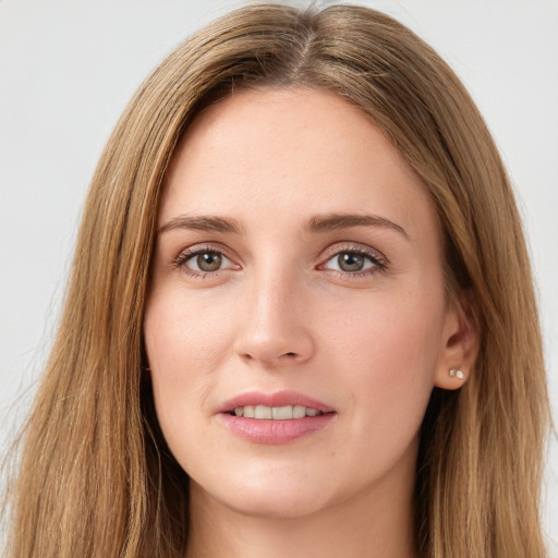 Joyful white young-adult female with long  brown hair and green eyes