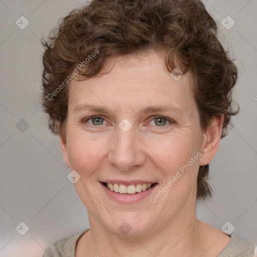 Joyful white adult female with medium  brown hair and blue eyes