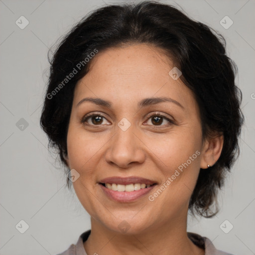 Joyful latino adult female with medium  brown hair and brown eyes