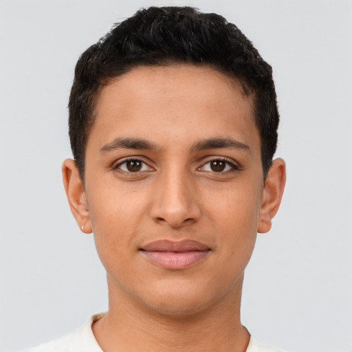 Joyful latino young-adult male with short  brown hair and brown eyes