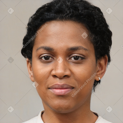 Joyful black young-adult female with short  black hair and brown eyes