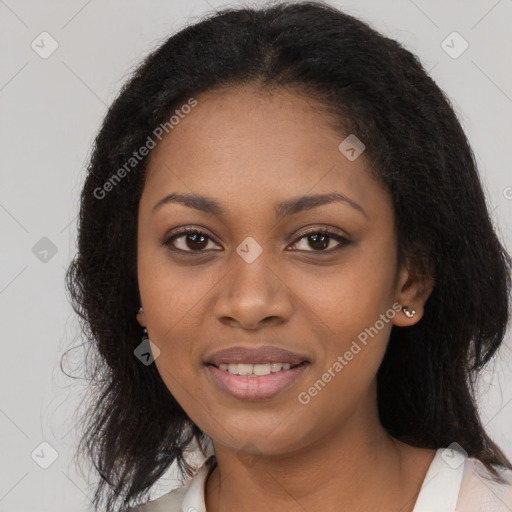 Joyful black young-adult female with long  black hair and brown eyes