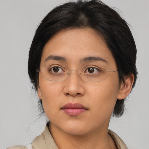 Neutral asian adult female with medium  brown hair and brown eyes