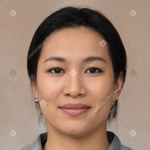 Joyful asian young-adult female with medium  black hair and brown eyes