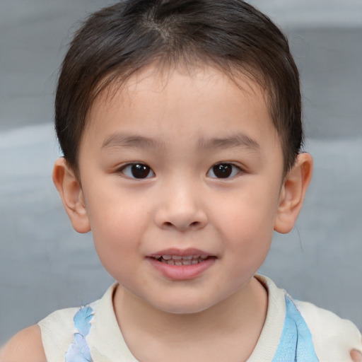 Joyful white child male with short  brown hair and brown eyes