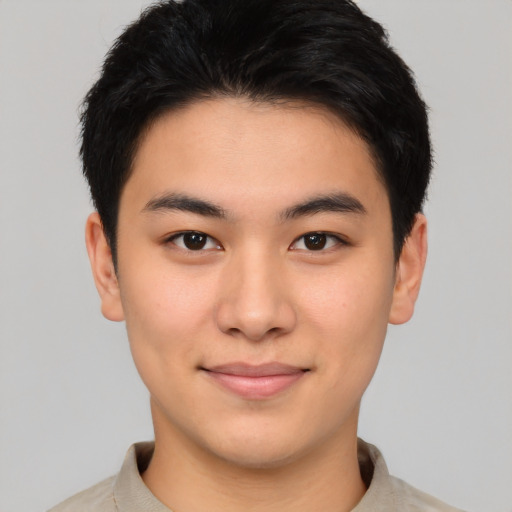 Joyful asian young-adult male with short  brown hair and brown eyes