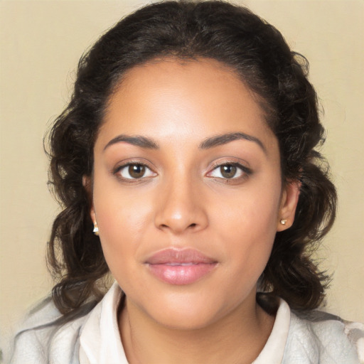 Joyful latino young-adult female with medium  brown hair and brown eyes