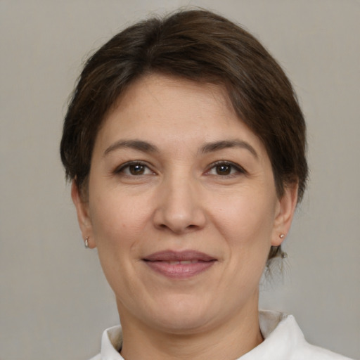 Joyful white adult female with medium  brown hair and brown eyes