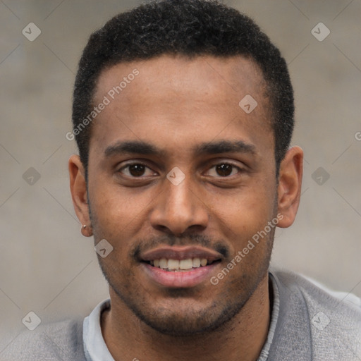 Joyful black young-adult male with short  black hair and brown eyes