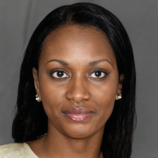 Joyful black young-adult female with long  black hair and brown eyes