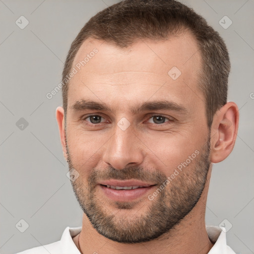 Joyful white young-adult male with short  brown hair and brown eyes