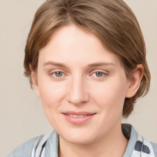 Joyful white young-adult female with medium  brown hair and blue eyes