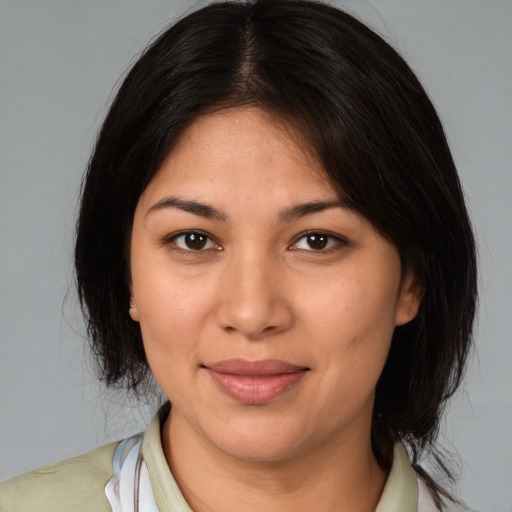 Joyful latino young-adult female with medium  brown hair and brown eyes