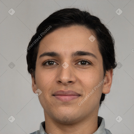 Joyful latino young-adult male with short  black hair and brown eyes