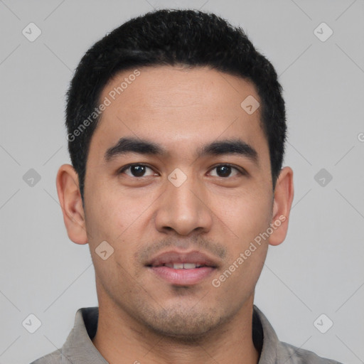 Joyful latino young-adult male with short  black hair and brown eyes