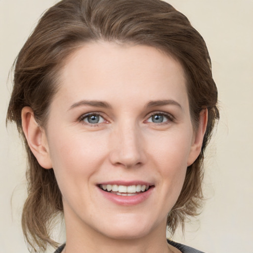 Joyful white young-adult female with medium  brown hair and grey eyes