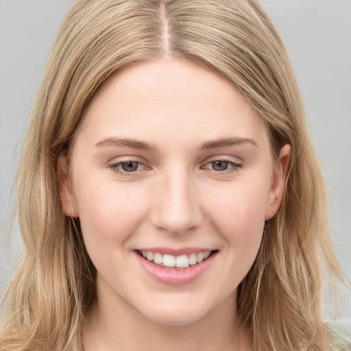 Joyful white young-adult female with long  brown hair and grey eyes