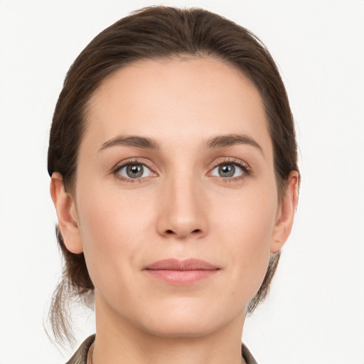 Joyful white young-adult female with medium  brown hair and grey eyes