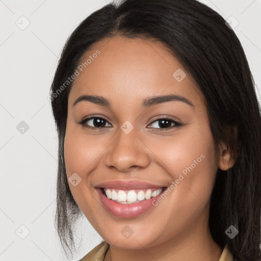 Joyful latino young-adult female with long  brown hair and brown eyes