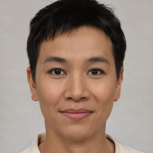 Joyful asian young-adult male with short  brown hair and brown eyes