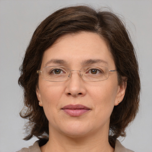 Joyful white adult female with medium  brown hair and grey eyes