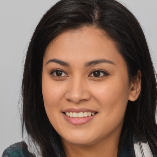 Joyful asian young-adult female with long  brown hair and brown eyes