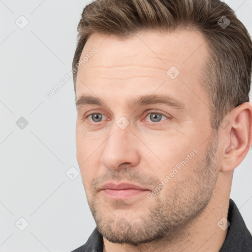 Joyful white adult male with short  brown hair and grey eyes