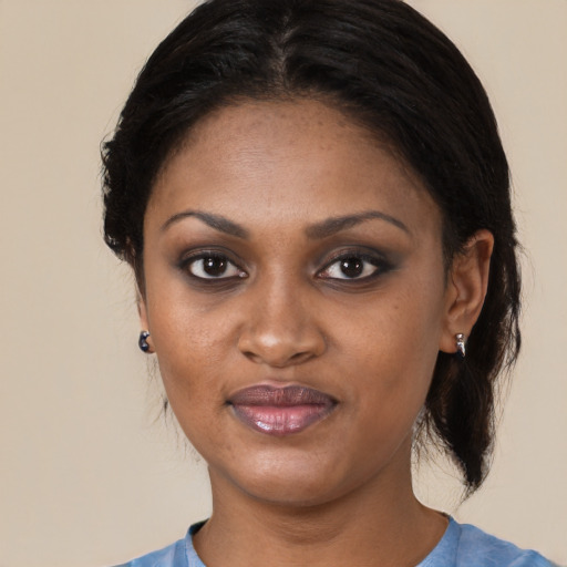 Joyful black young-adult female with medium  black hair and brown eyes