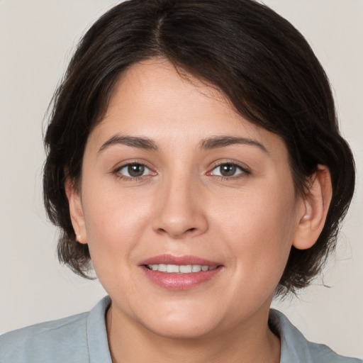 Joyful white young-adult female with medium  brown hair and brown eyes