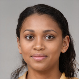 Joyful black young-adult female with long  brown hair and brown eyes