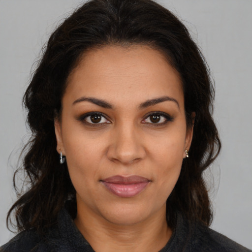 Joyful latino young-adult female with medium  brown hair and brown eyes