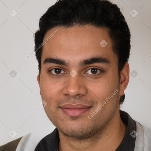 Joyful latino young-adult male with short  black hair and brown eyes