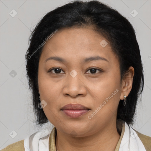 Joyful latino adult female with medium  brown hair and brown eyes