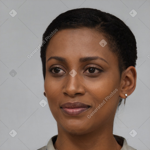 Joyful black young-adult female with short  black hair and brown eyes