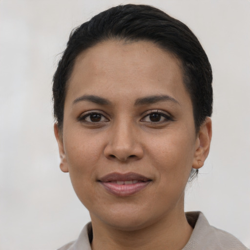Joyful latino young-adult female with short  black hair and brown eyes