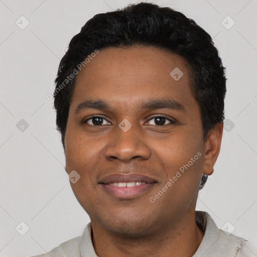 Joyful black young-adult male with short  black hair and brown eyes