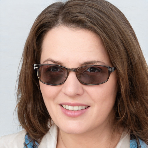 Joyful white young-adult female with medium  brown hair and blue eyes