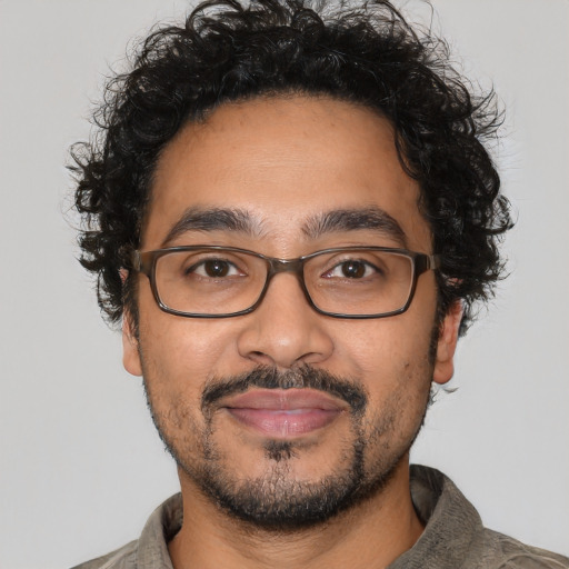 Joyful latino adult male with short  brown hair and brown eyes