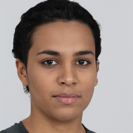 Joyful latino young-adult female with short  black hair and brown eyes
