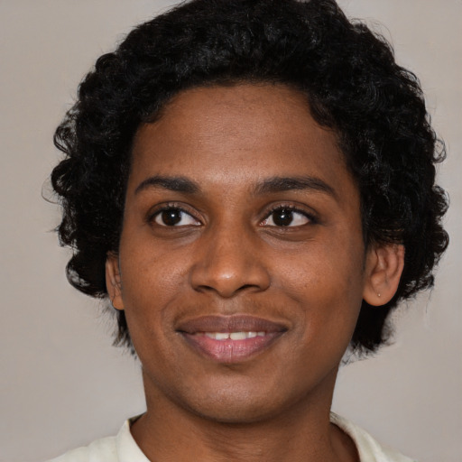 Joyful latino young-adult female with short  black hair and brown eyes