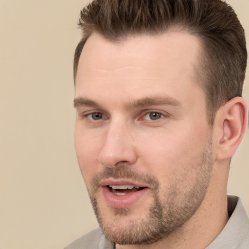 Joyful white young-adult male with short  brown hair and brown eyes