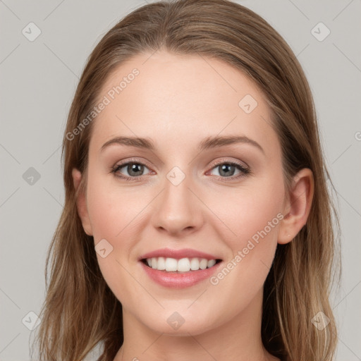 Joyful white young-adult female with long  brown hair and blue eyes